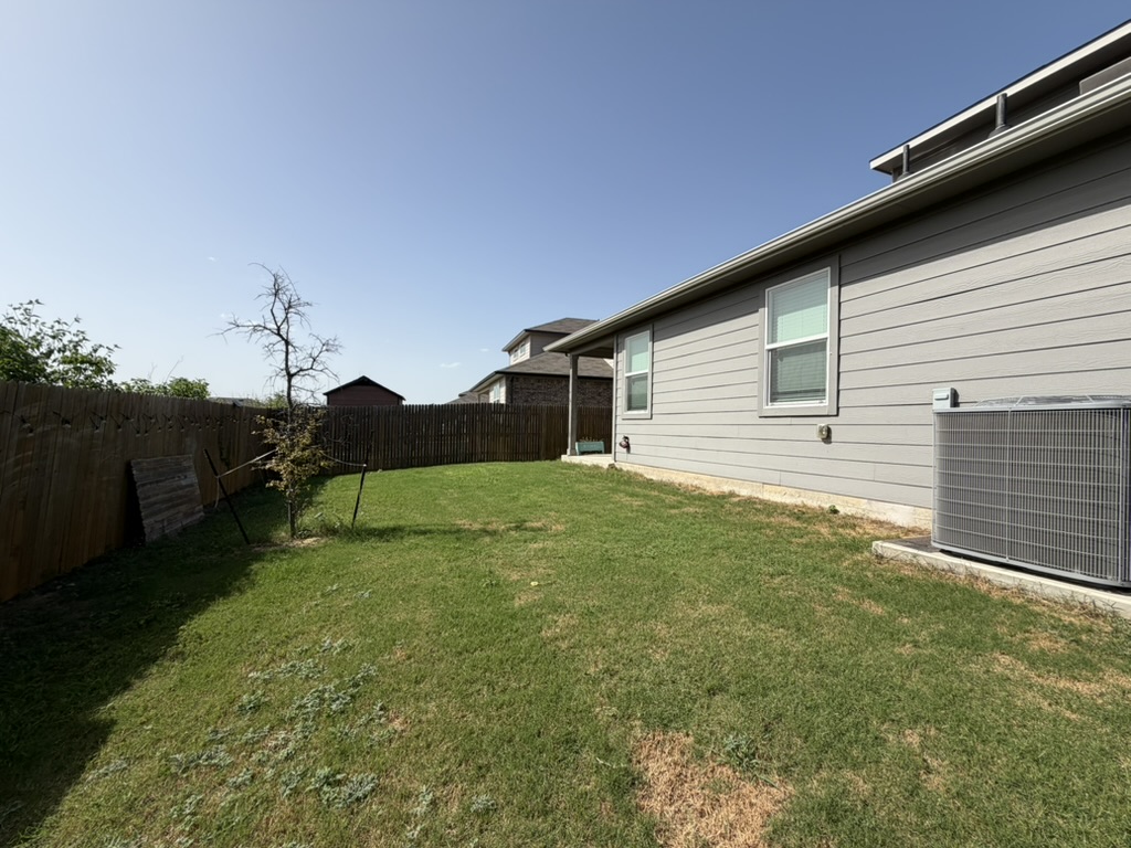 10708 Gonzales Ranger Pass Austin, TX 78754 - Photo 22 of 40 A generous backyard offers private outdoor space, enclosed by sturdy fencing.