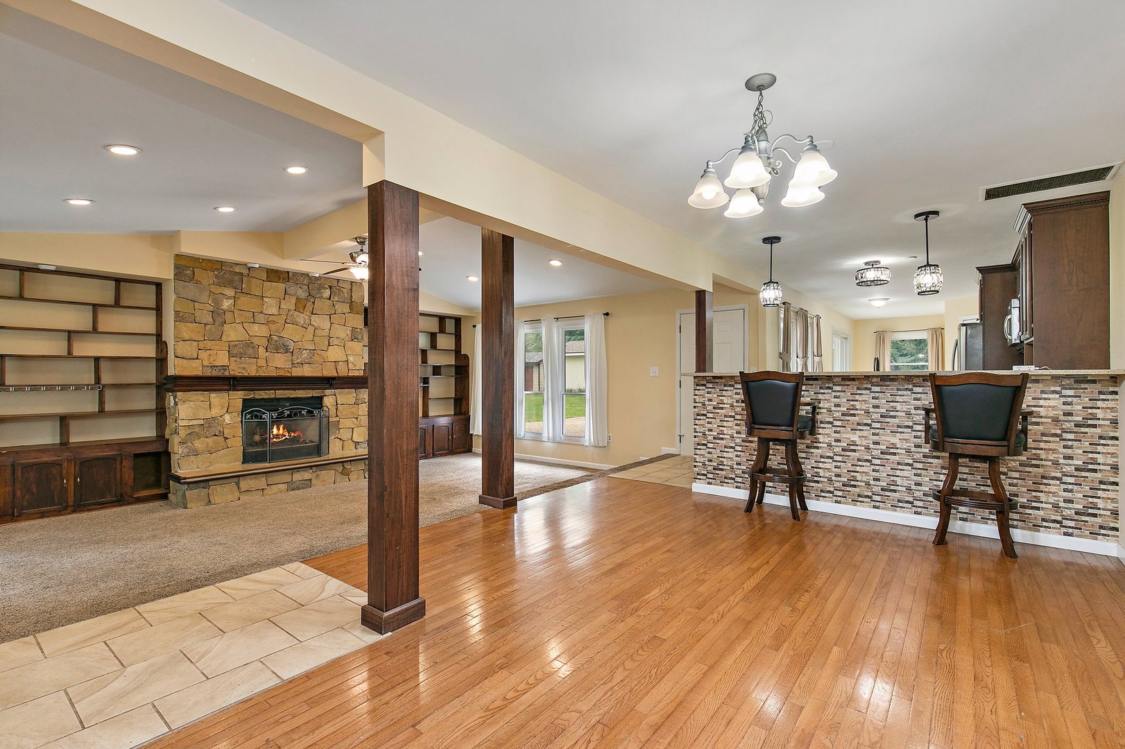 1026 Oak Ridge Road Carpentersville, IL 60110 - Photo 4 of 25 a view of a livingroom with furniture a fireplace wooden floor and chandelier