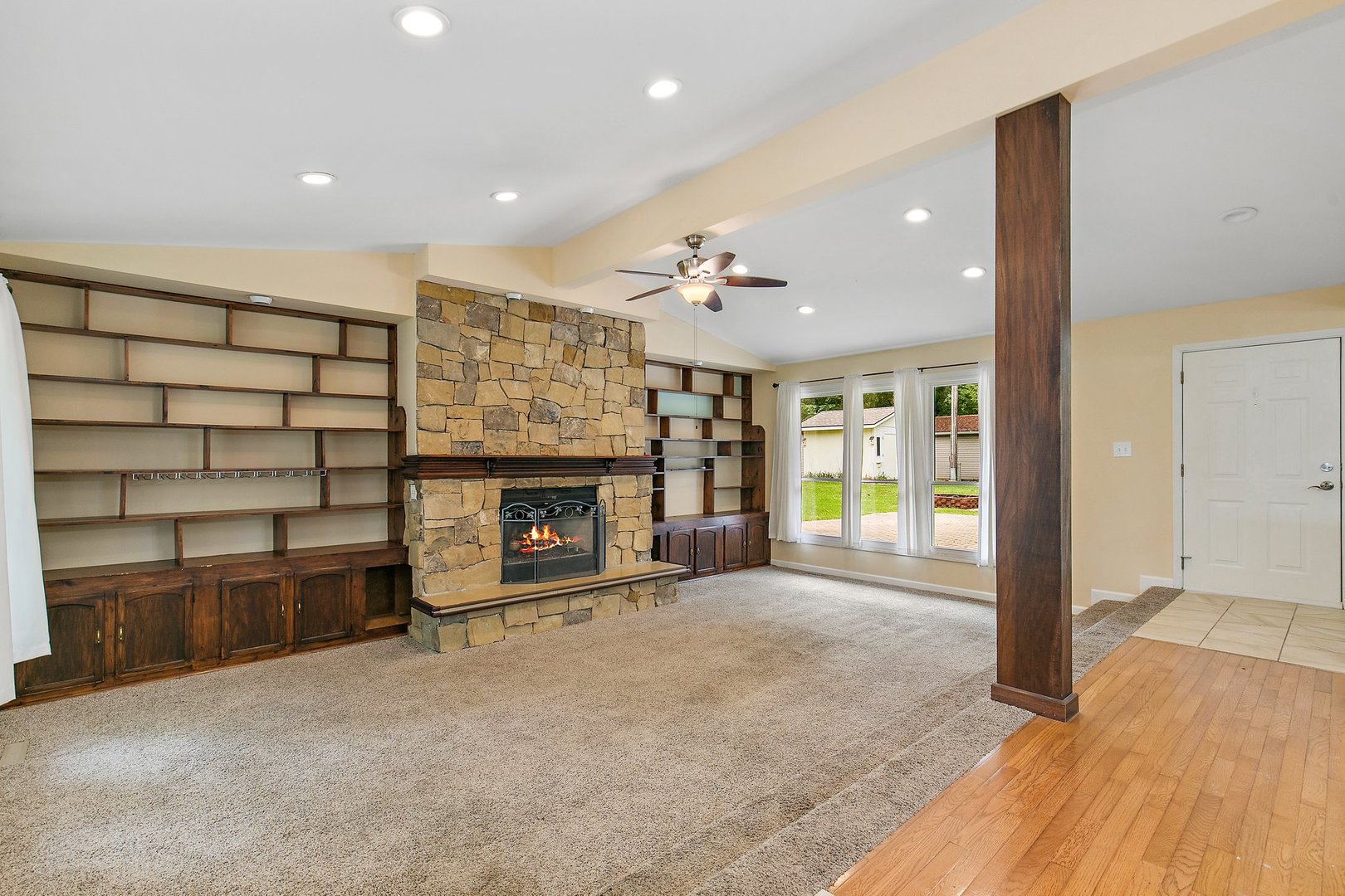 1026 Oak Ridge Road Carpentersville, IL 60110 - Photo 5 of 25 a view of an empty room with a fireplace and a workspace