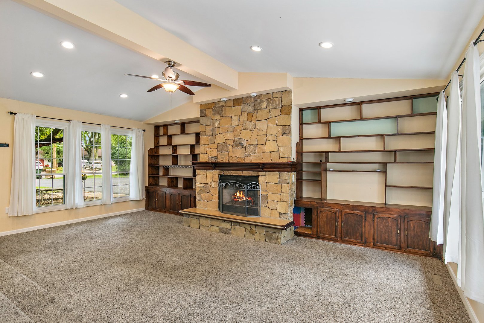 1026 Oak Ridge Road Carpentersville, IL 60110 - Photo 6 of 25 a view of an empty room with a fireplace and a window