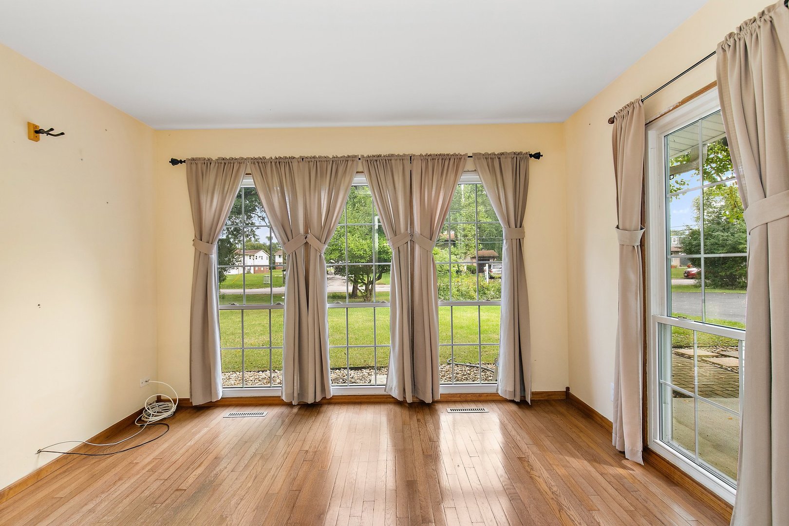 1026 Oak Ridge Road Carpentersville, IL 60110 - Photo 8 of 25 wooden floor in an empty room with a window