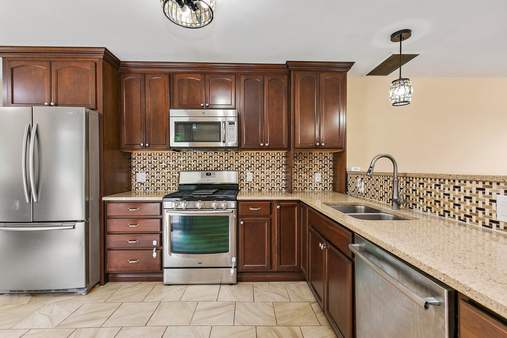 1026 Oak Ridge Road Carpentersville, IL 60110 - Photo 9 of 25 a kitchen with stainless steel appliances granite countertop a sink stove and refrigerator