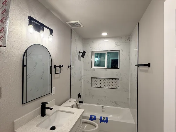 a bathroom with a sink a shower and a mirror