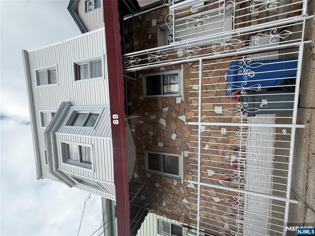 65 Grand Street Paterson, NJ 07501 - Photo 1 of 9 a view of a balcony with a floor to ceiling window