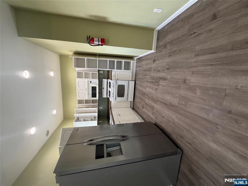 65 Grand Street Paterson, NJ 07501 - Photo 2 of 9 a kitchen with stainless steel appliances a refrigerator and a stove top oven