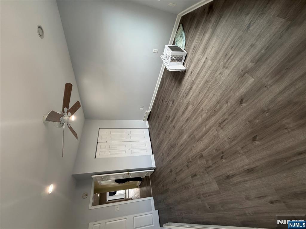 65 Grand Street Paterson, NJ 07501 - Photo 5 of 9 a view of empty room with wooden floor and fan