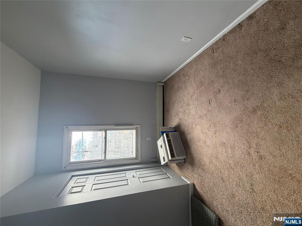 65 Grand Street Paterson, NJ 07501 - Photo 6 of 9 an empty room with a window