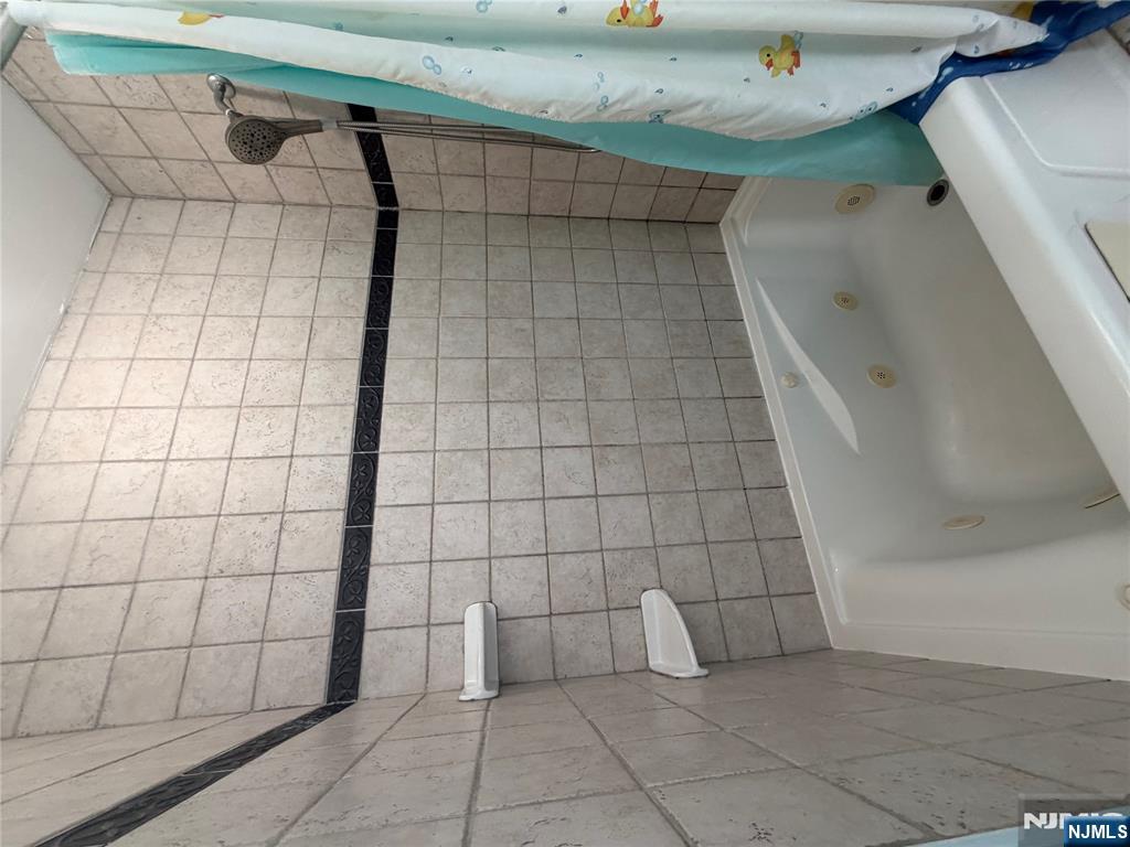 65 Grand Street Paterson, NJ 07501 - Photo 8 of 9 a bathroom with a bathtub