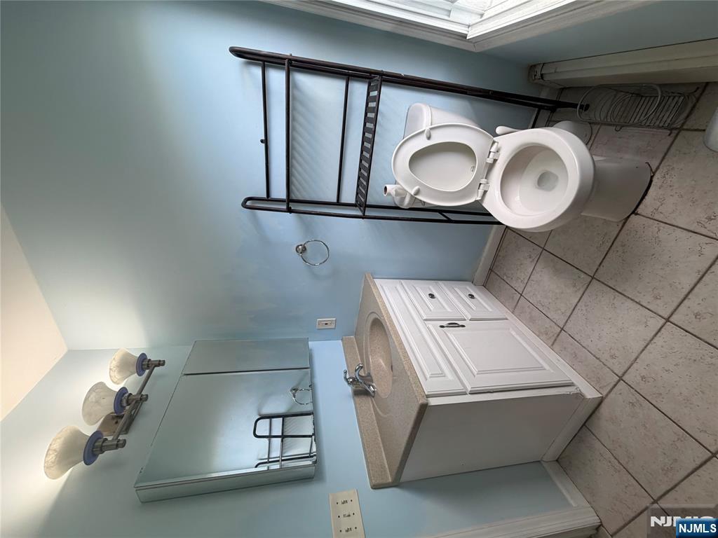 65 Grand Street Paterson, NJ 07501 - Photo 9 of 9 a bathroom with a toilet sink and mirror