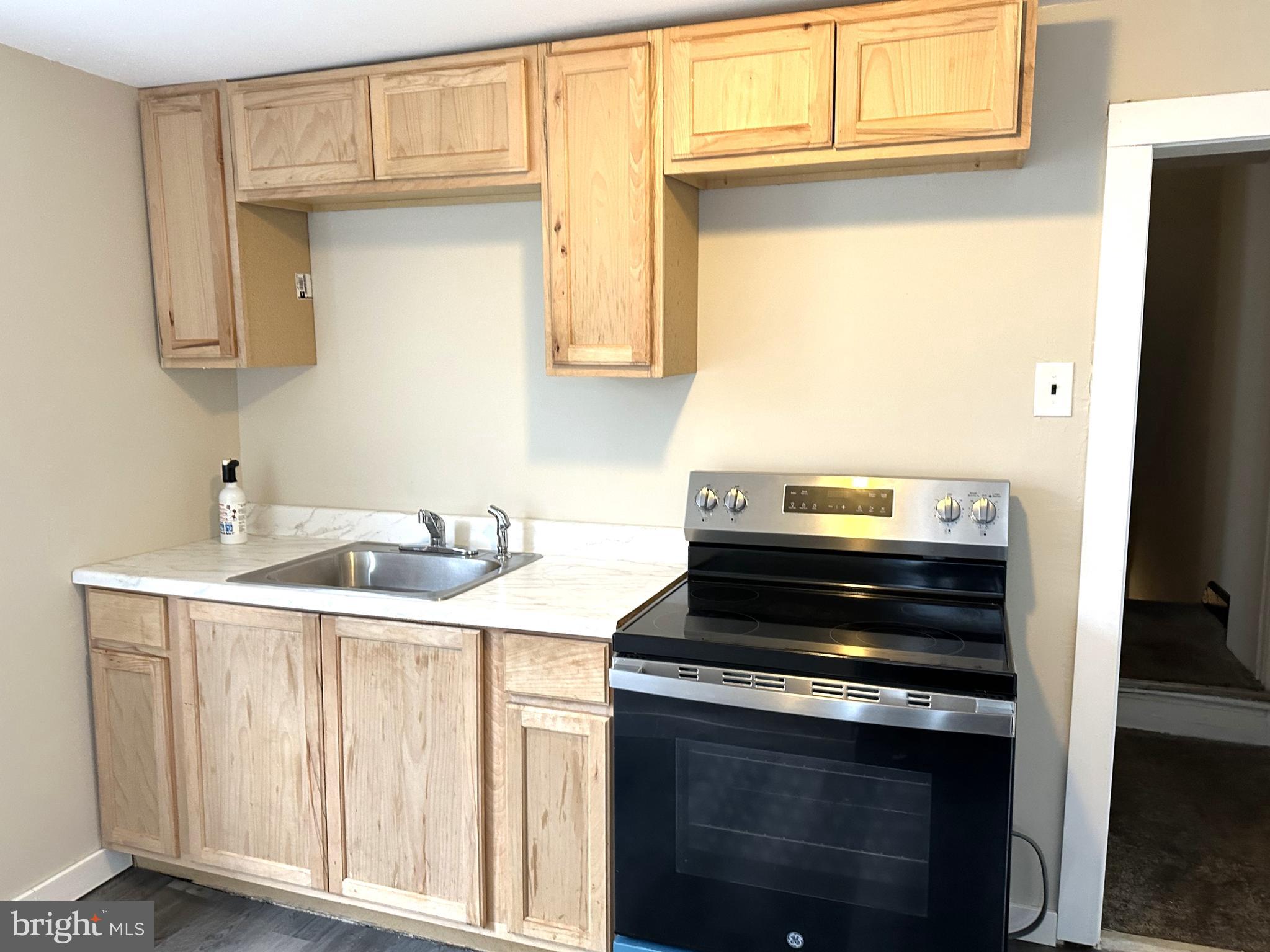 a kitchen with a stove and a sink