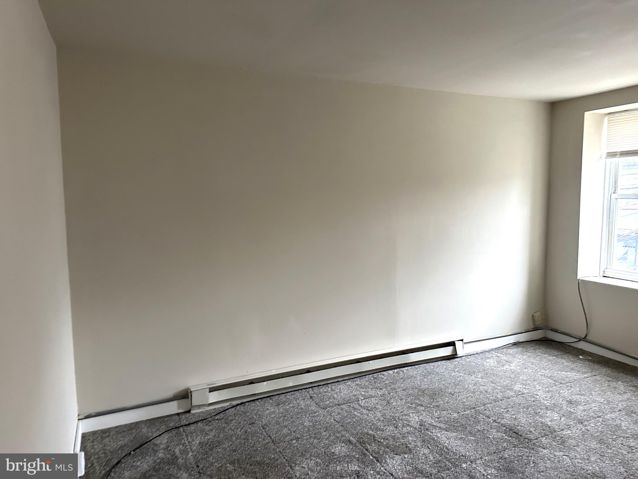 425 Highland Avenue, Unit B Chester, PA 19013 - Photo 11 of 25 an empty room with windows