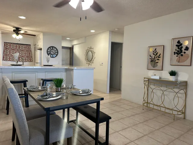 a kitchen with stainless steel appliances granite countertop a sink a stove and cabinets