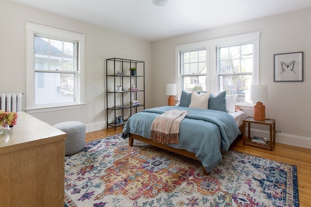 76 Prince Street Boston, MA 02130 - Photo 16 of 23 a bedroom with a bed and wooden floor