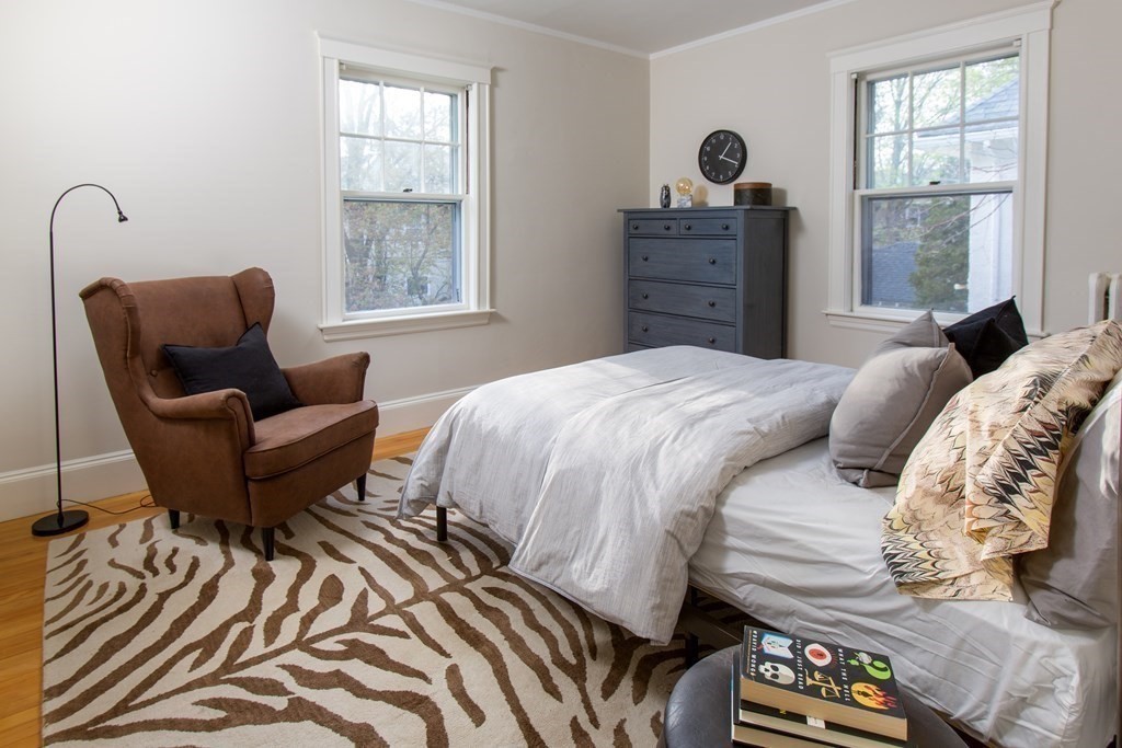 76 Prince Street Boston, MA 02130 - Photo 17 of 23 a bedroom with a bed and wooden floor