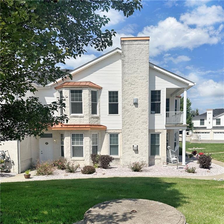 228 Adams Pointe Boulevard, Unit 7 Mars, PA 16046 - Photo 1 of 27 a front view of a house with garden and trees