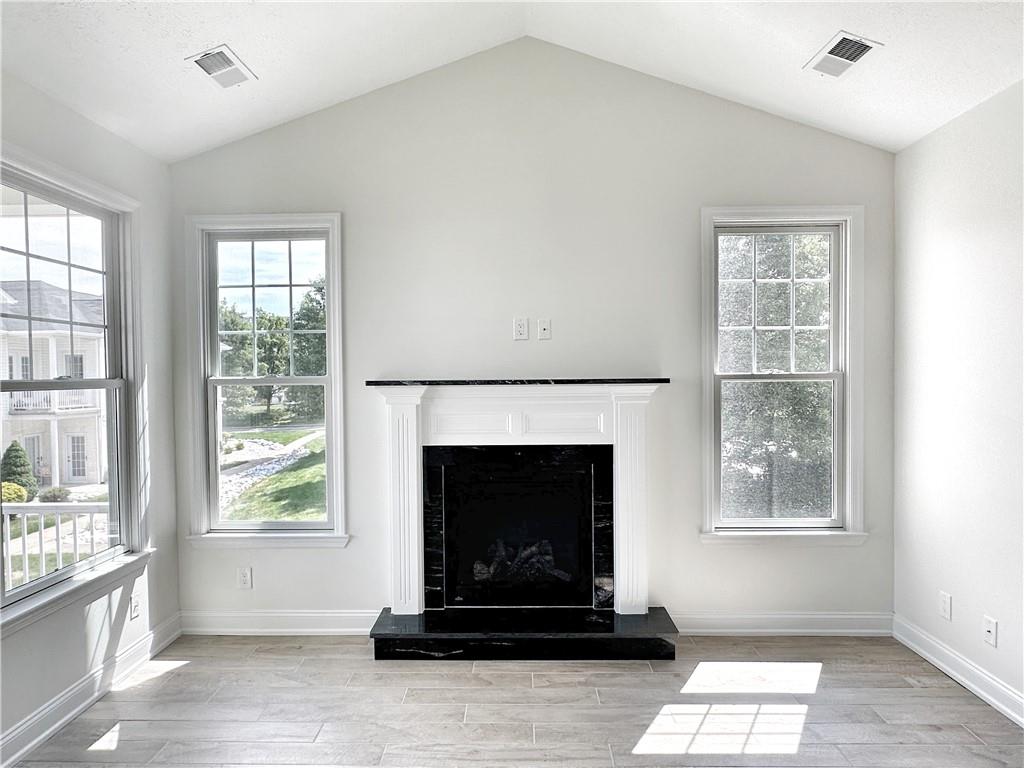 228 Adams Pointe Boulevard, Unit 7 Mars, PA 16046 - Photo 11 of 27 a living room with a fireplace and windows
