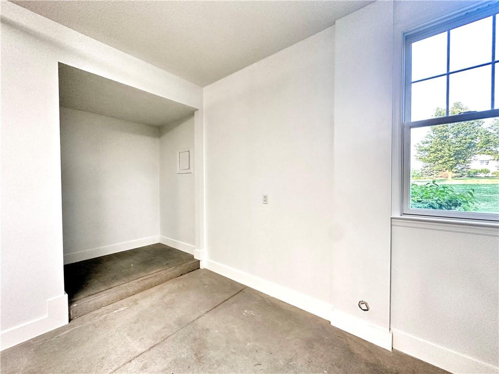 228 Adams Pointe Boulevard, Unit 7 Mars, PA 16046 - Photo 26 of 27 an empty room with large windows