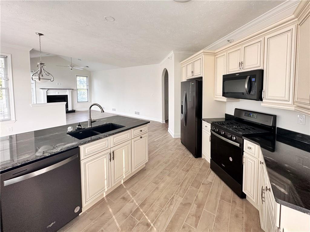 228 Adams Pointe Boulevard, Unit 7 Mars, PA 16046 - Photo 6 of 27 a kitchen with stainless steel appliances granite countertop a sink and a stove