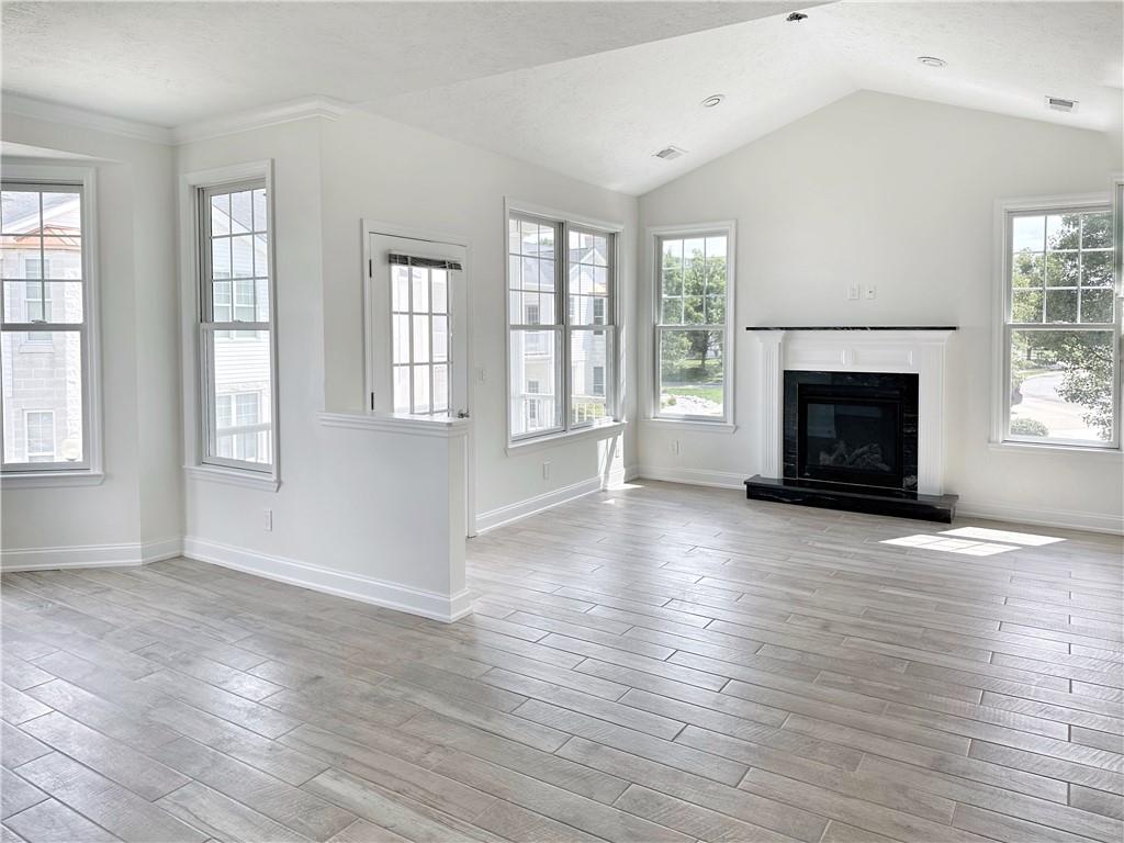 228 Adams Pointe Boulevard, Unit 7 Mars, PA 16046 - Photo 10 of 27 an empty room with windows and fireplace