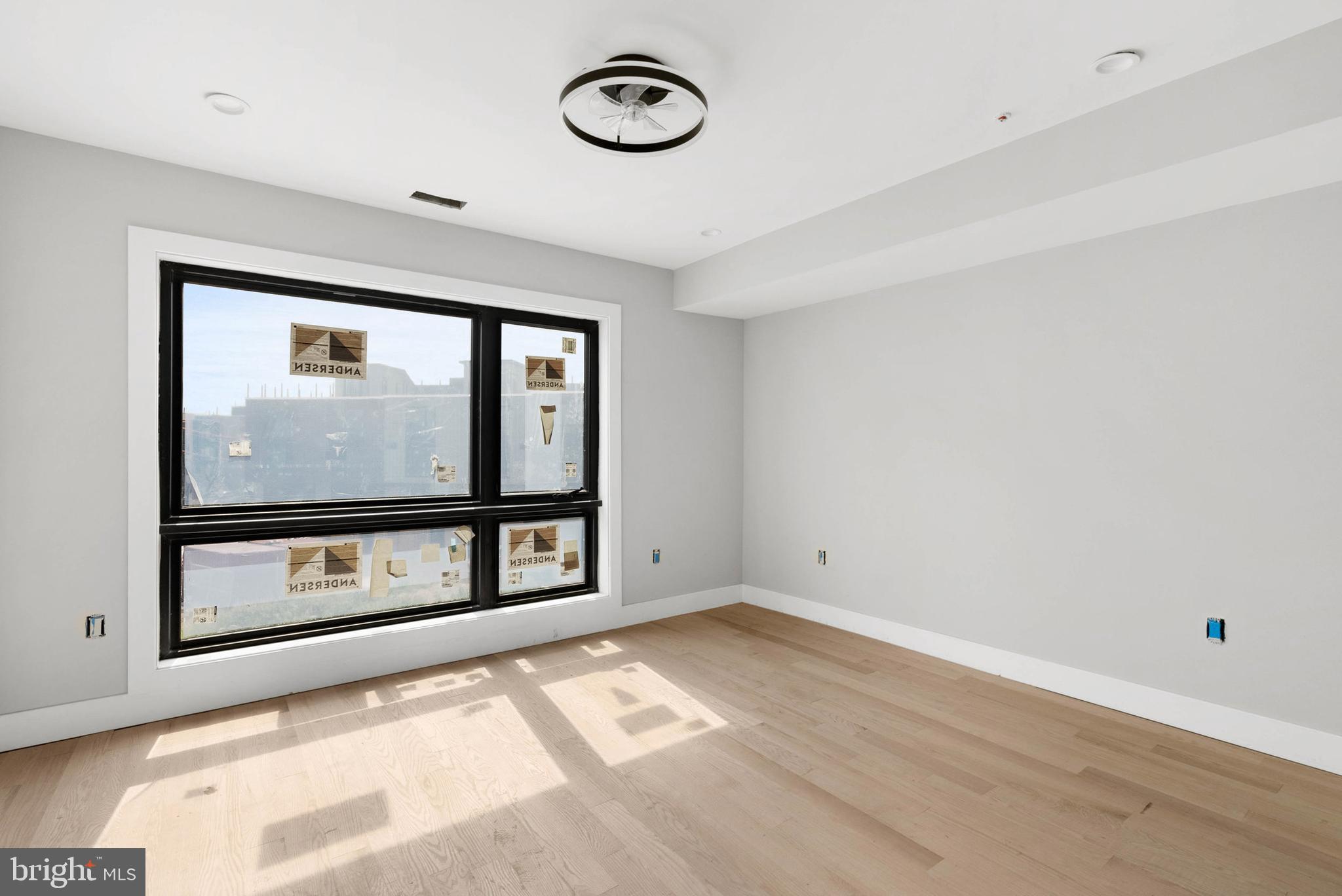 830 Cameron Street Philadelphia, PA 19130 - Photo 3 of 18 a view of an empty room with wooden floor and a window