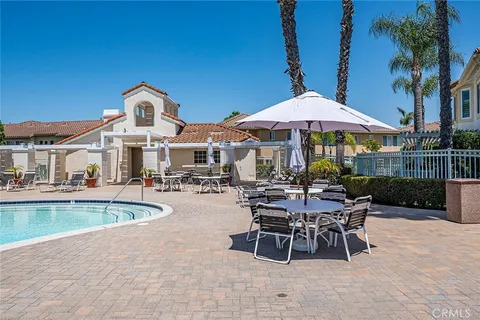 a view of a house with swimming pool and sitting area