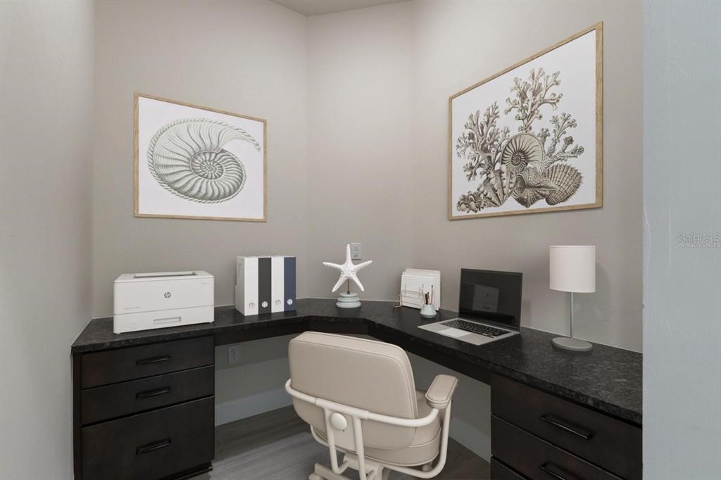 712 Sigsbee Loop Sarasota, FL 34240 - Photo 12 of 59 a table with a chair and painting on the wall