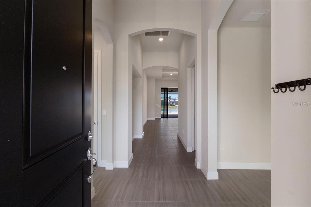 712 Sigsbee Loop Sarasota, FL 34240 - Photo 7 of 59 a view of a hallway with wooden floor