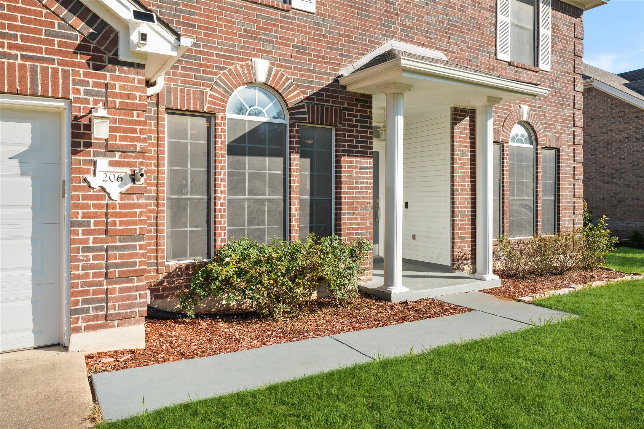 206 River Down Road Georgetown, TX 78628 - Photo 3 of 39 Brick exterior with an arched entry window and covered porch