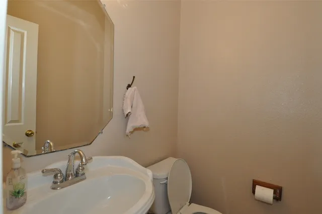 a view of a living room and chandelier fan