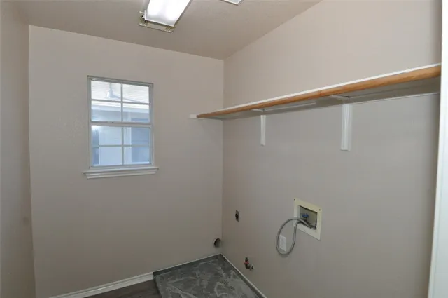 a view of a house with a yard and wooden fence