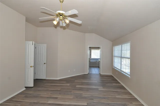 a view of an empty room with wooden floor