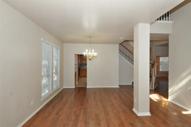 a view of livingroom with hardwood floor and stairs