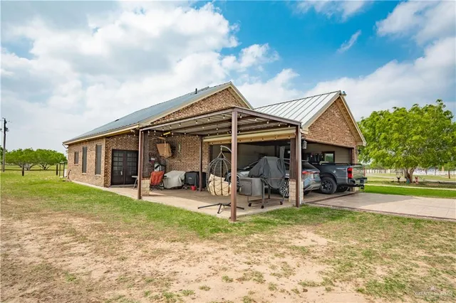 a view of a house with a yard and sitting area