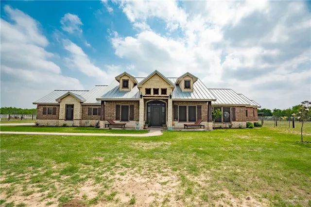 a front view of a house with a big yard