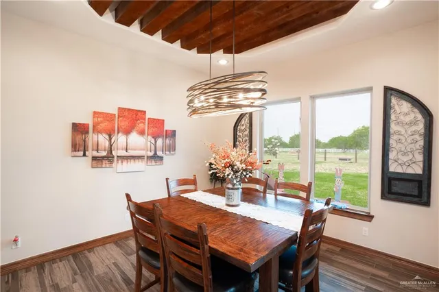 a dining room with furniture a chandelier and window