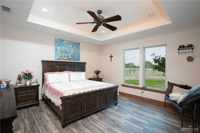 a bedroom with a bed a window and a chandelier