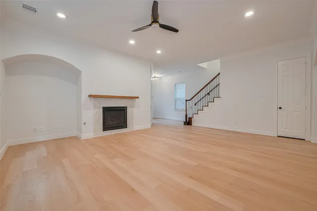 a view of a kitchen with a sink and dishwasher a refrigerator with white cabinets