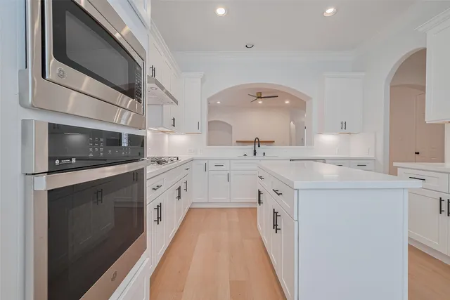 an empty room with a window and ceiling fan