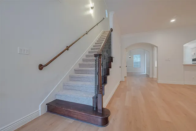 a view of empty room with wooden floor and fireplace