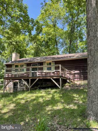 Charming cabin nestled among lush trees.