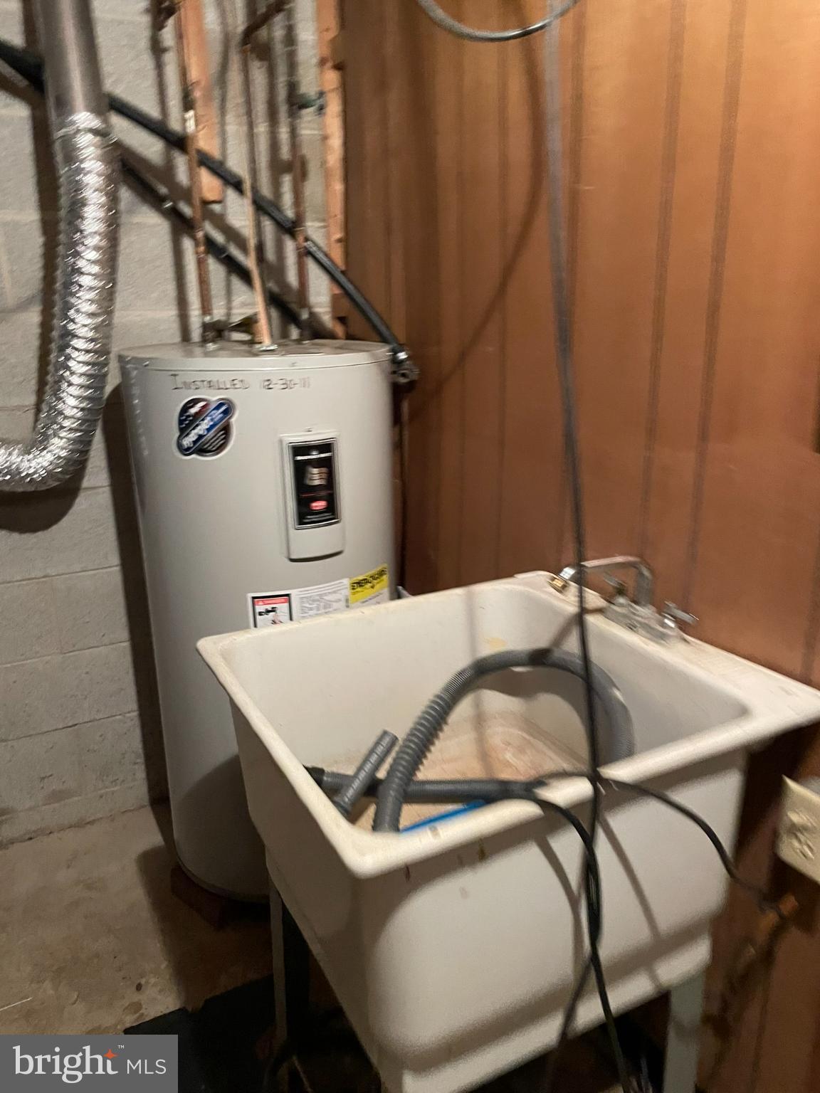779 Center School Road Perkasie, PA 18944 - Photo 13 of 15 Utility space with water heater and sink.