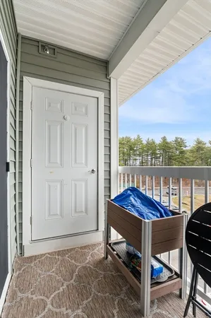 a view of a balcony with furniture and a floor to ceiling window