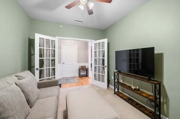 a living room with furniture and a flat screen tv
