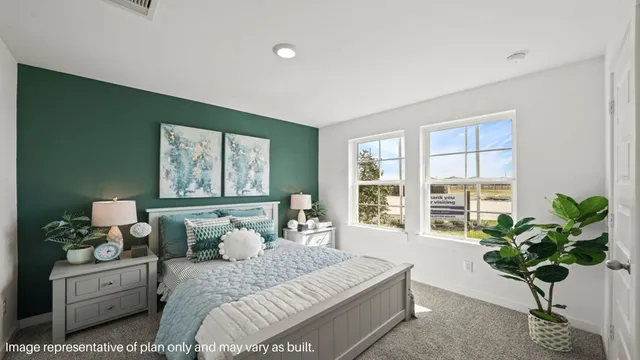 a bedroom with a bed and a potted plant