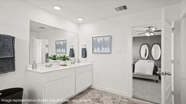 a en suite bathroom with 2 sink and a mirror