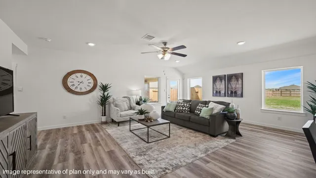 a living room with furniture a clock and a window