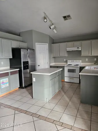 a kitchen with cabinets stainless steel appliances and a counter top
