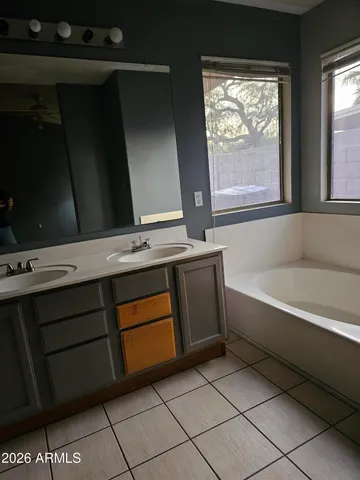 a bathroom with a bathtub and a window