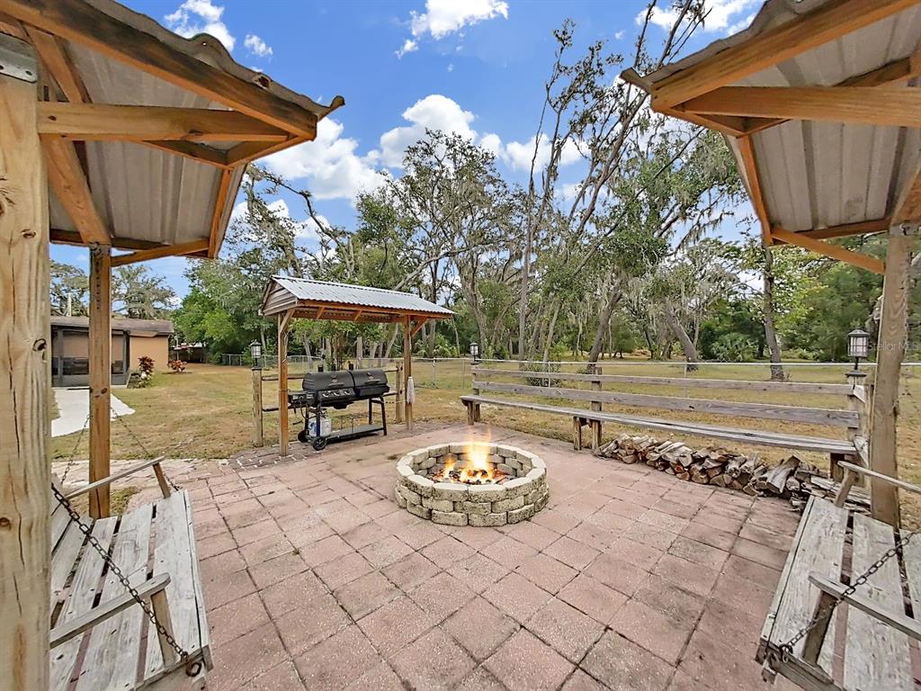4105 Robinson Road Valrico, FL 33594 - Photo 14 of 58 a view of a patio with table and chairs potted plants