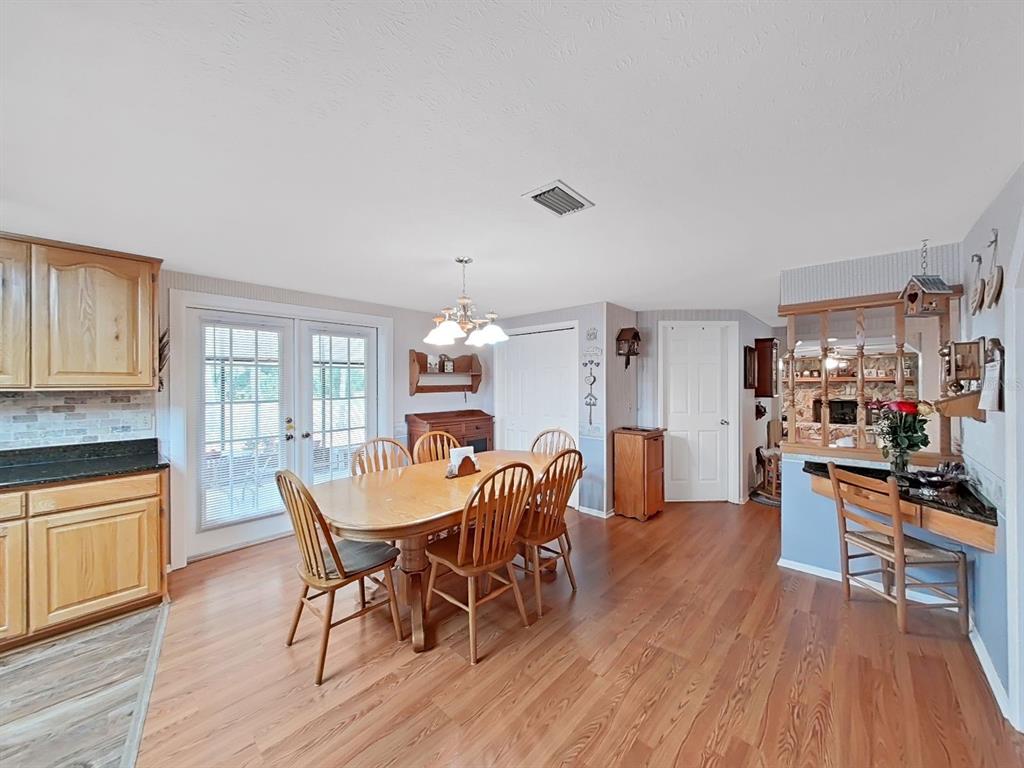 4105 Robinson Road Valrico, FL 33594 - Photo 19 of 58 a view of a dining room with furniture and wooden floor